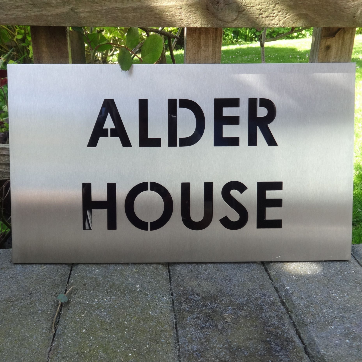 Stainless Steel House Name, custom made house name, bespoke house name, metal house name. metal and black house name, black house name, laser cut house name, modern house name, contemporary house name, made to der house name, steel house name, house sign in stainless steel, stainless steel house sign