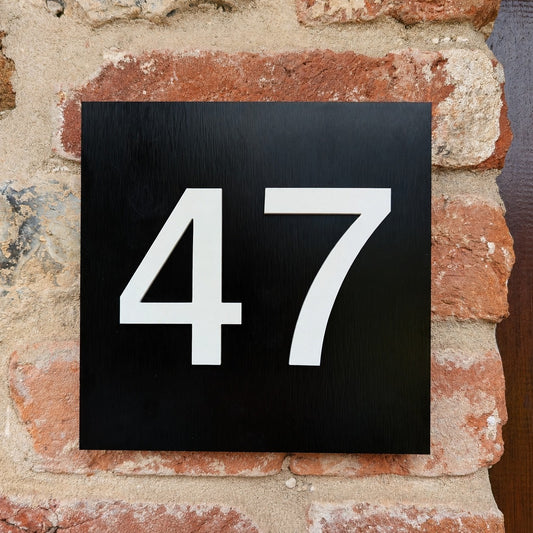 Black House Number Plaque - matt white acrylic numbers mounted onto brushed black